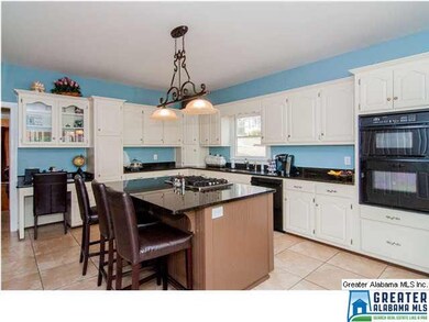 Gas cooktop is conveniently located on the island.