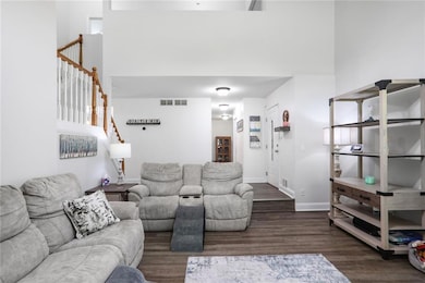 Living area featuring stairway and wood finished floors