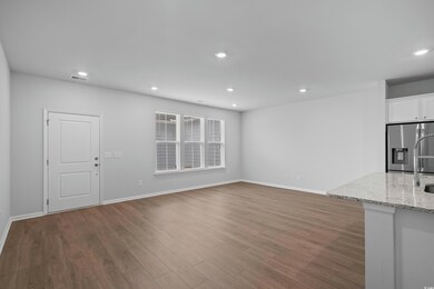 Unfurnished living room with wood finished floors,