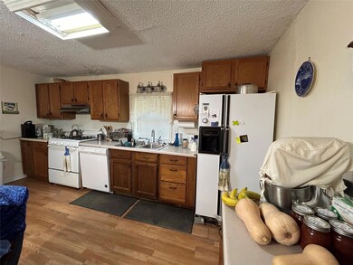 Kitchen with light hardwood / wood-style flooring,