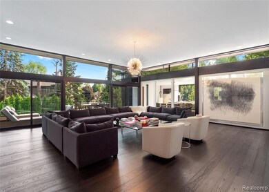 Living room featuring a wall of windows, dark wood-style floors, a chandelier, and recessed lighting