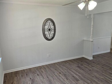 Living room features crown molding, vinyl plank fl