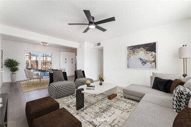 Living room with a ceiling fan and wood finished f