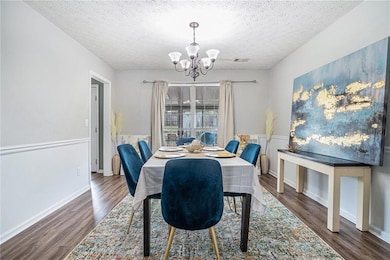 Dining space featuring an inviting chandelier, a t