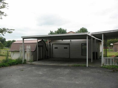 Double detached carport, with front view garage with living quarters.
