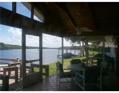 Covered screen porch with tile flooring over looki