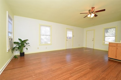 Unfurnished living room featuring a ceiling fan, 