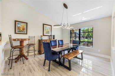 Dining space featuring lofted ceiling, light hardw