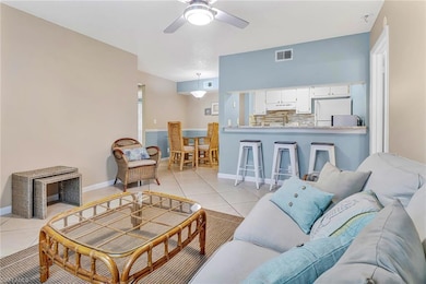 Living room featuring sink, light tile patterned floors, and ceiling fan