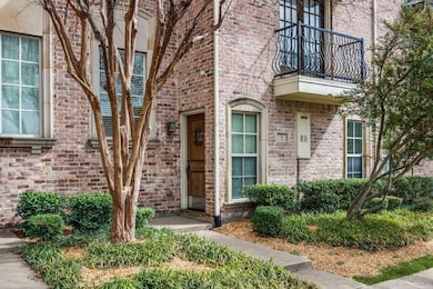 Property entrance featuring brick siding and a bal