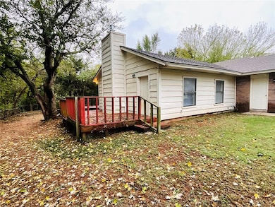 View of home's exterior with a yard and a deck