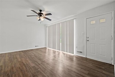 Entrance foyer featuring ceiling fan and dark hardwood / wood-style flooring