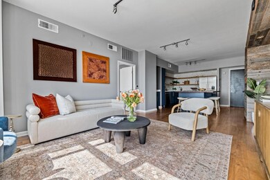Living area with rail lighting, wood finished flo