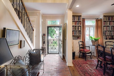 Foyer entrance featuring ornamental molding, stairs, and recessed lighting,.