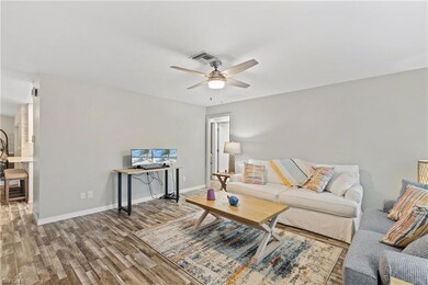 Living room with ceiling fan and hardwood / wood-s