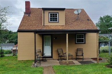 Back of home with covered patio