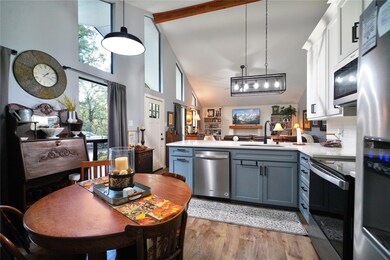 Kitchen featuring kitchen peninsula, appliances wi