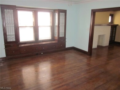 Empty room featuring plenty of natural light, dark hardwood / wood-style flooring, and a fireplace
