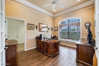Office area featuring ceiling fan, dark hardwood /