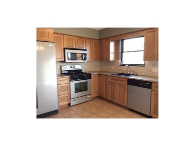 Tile floor in kitchen and stainless steel applianc