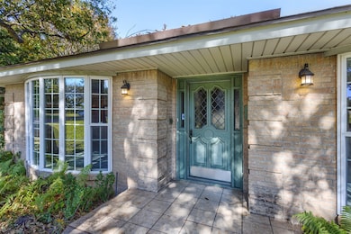 Property entrance featuring brick siding