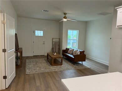 Living room featuring visible vents, baseboards, a