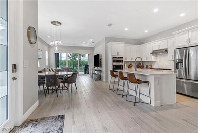 Kitchen featuring wood tiled floor, a breakfast ba