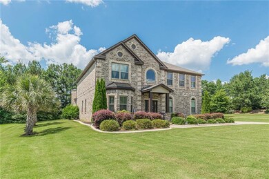 View of front of property with brick siding and a front lawn