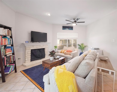 Living room featuring tile patterned floors, a fi