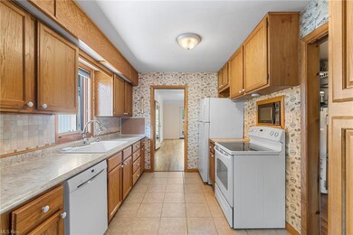 Kitchen featuring, light tile flooring, backsplash