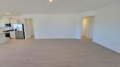 Unfurnished living room featuring light wood finished floors and recessed lighting