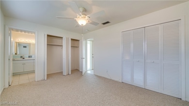 Unfurnished bedroom featuring light carpet, sink,