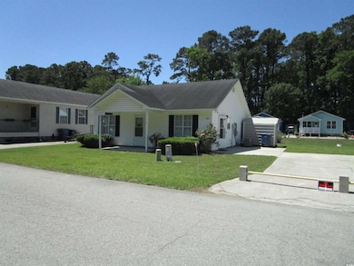 Ranch-style home featuring a front yard and concrete driveway