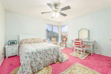 Bedroom with carpet flooring and a ceiling fan