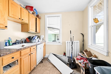Clothes washing area featuring radiator heating un