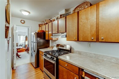 View to the dining room. New stainless refrigerato