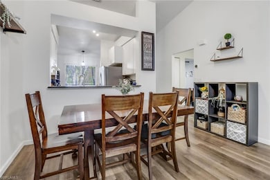 Dining area featuring wood finished floors and bas