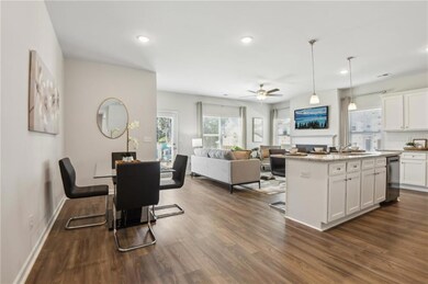 Kitchen with dark wood finished floors, white cabi
