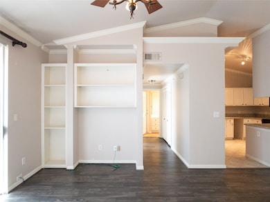 crown molding; built-ins in living room; hall to bedroom, bath, laundry
