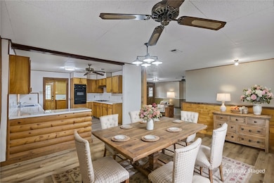 Dining area with light wood-style flooring, visibl