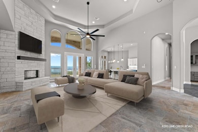Living room with a towering ceiling, arched walkw