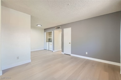 Living room with view of washer/dryer and dining a