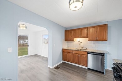 Kitchen with appliances with stainless steel finishes,, sink, and wood-type flooring