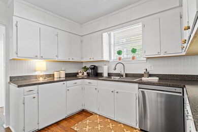 Kitchen featuring a sink, dark wood-type flooring,