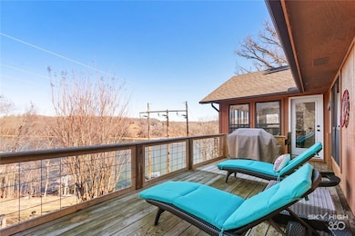 Back deck just off your sunroom overlooks the lake