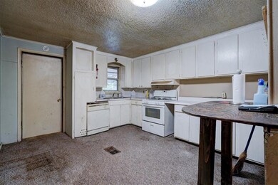 Kitchen with a textured ceiling, ornamental moldin