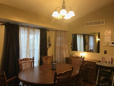 Dining room has sliders to covered deck with a cei