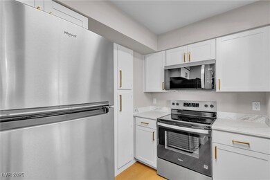 Kitchen featuring stainless steel appliances, a si