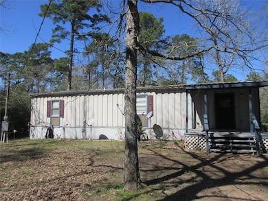 Front of this metal home on shared 2 acre lot