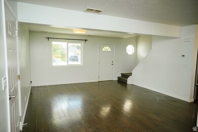 Entrance foyer featuring hand scraped dark wood finished floors and stairway